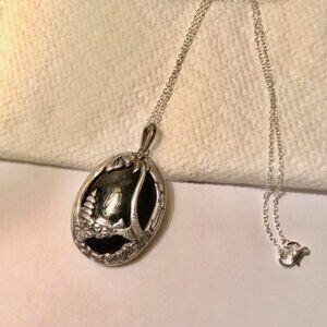 A classic enamel-backed scenic pendant popular in mid‑century Southeast Asian